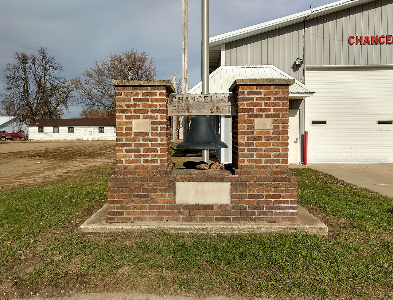 The fire bell sitting in front of the Chancellor Fire Station