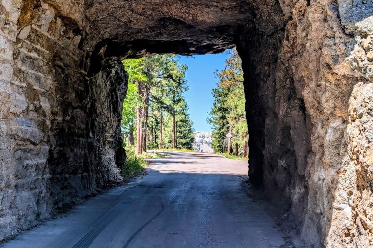 View through a tunnel from Iron Mountain Road in the Black Hills. Through the tunnel you can see Mt. Rushmore. Copyright 2026 by Bryan Ruby